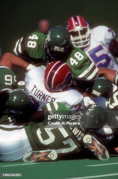 Strong Safety Brian Washington and Linebacker Mo Lewis of the New York Jets stop Fullback Nate Turner of the Buffalo Bills in the game between the...