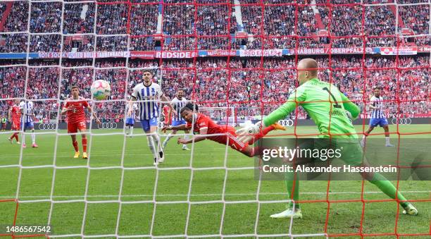 Serge Gnabry of FC Bayern Munich scores the team's first goal past Oliver Christensen of Hertha Berlin during the Bundesliga match between FC Bayern...