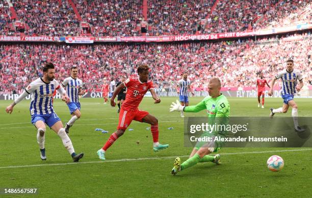 Kingsley Coman of FC Bayern Munich scores the team's second goal past Oliver Christensen of Hertha Berlin during the Bundesliga match between FC...