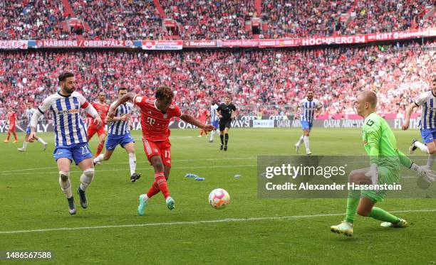 Kingsley Coman of FC Bayern Munich scores the team's second goal past Oliver Christensen of Hertha Berlin during the Bundesliga match between FC...
