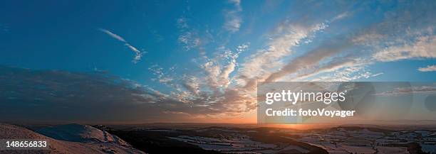 golden sunset idyllic winter landscape hills patchwork farms fields panorama - winterzonnewende stockfoto's en -beelden