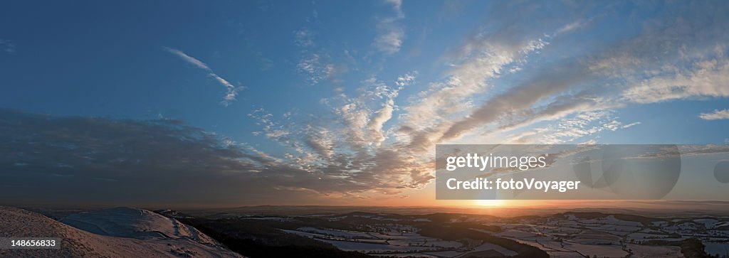 Golden sunset idyllic winter landscape hills patchwork farms fields panorama