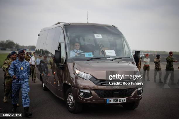 Minibus standing in as The Gold State Coach takes part in a full tri-service and Commonwealth rehearsal on the runway at RAF Odiham on April 30, 2023...
