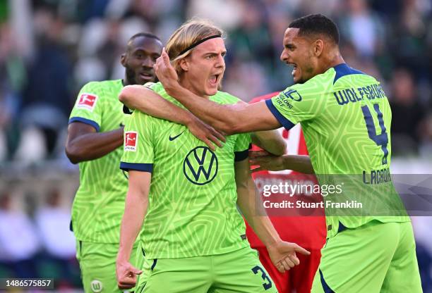 Sebastiaan Bornauw of VfL Wolfsburg celebrates with teammate Maxence Lacroix after scoring the team's second goal during the Bundesliga match between...