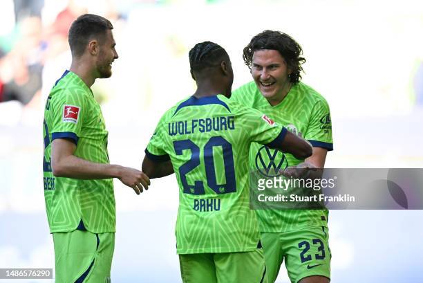 Jonas Wind of VfL Wolfsburg celebrates with teammate Ridle Baku after scoring the team's third goal during the Bundesliga match between VfL Wolfsburg...