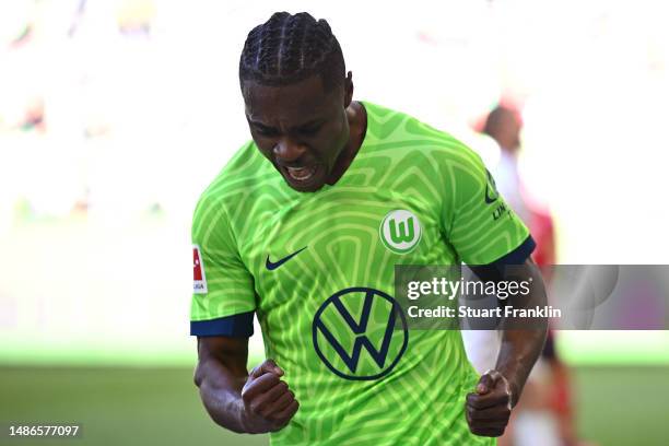 Ridle Baku of VfL Wolfsburg celebrates after teammate Jonas Wind scores the team's third goal during the Bundesliga match between VfL Wolfsburg and...