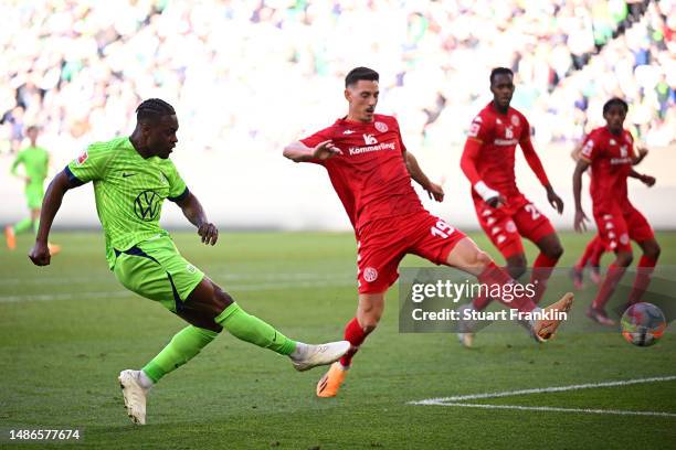 Ridle Baku of VfL Wolfsburg shoots before teammate Jonas Wind scores the team's third goal during the Bundesliga match between VfL Wolfsburg and 1....