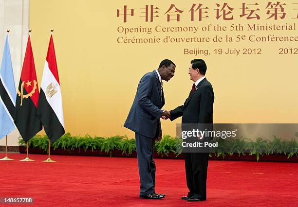 Benin President Thomas Yayi Boni shakes hands with Chinese president Hu Jintao prior to a group photo session for the 5th Ministerial Conference of...