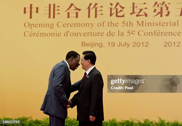 Benin President Thomas Yayi Boni shakes hands with Chinese president Hu Jintao prior to a group photo session for the 5th Ministerial Conference of...