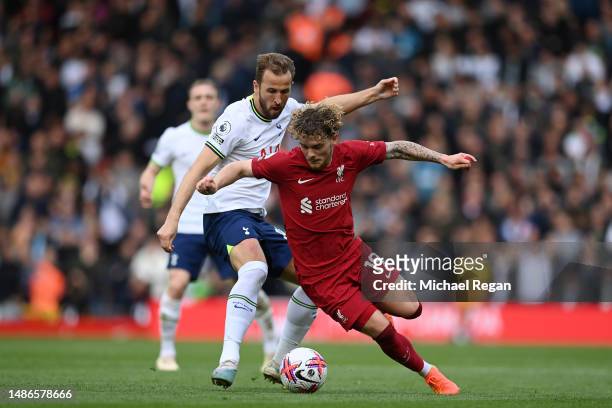 Harvey Elliott of Liverpool is put under pressure by Harry Kane of Tottenham Hotspur during the Premier League match between Liverpool FC and...