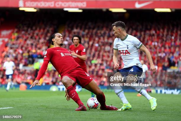Virgil van Dijk of Liverpool slips whilst under pressure from Ivan Perisic of Tottenham Hotspur during the Premier League match between Liverpool FC...