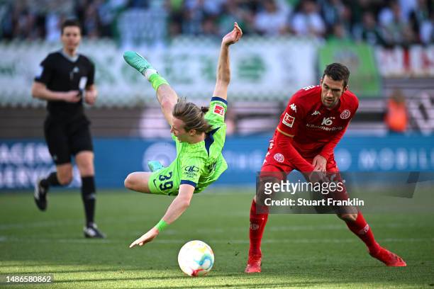 Patrick Wimmer of VfL Wolfsburg is fouled by Stefan Bell of 1.FSV Mainz 05 during the Bundesliga match between VfL Wolfsburg and 1. FSV Mainz 05 at...