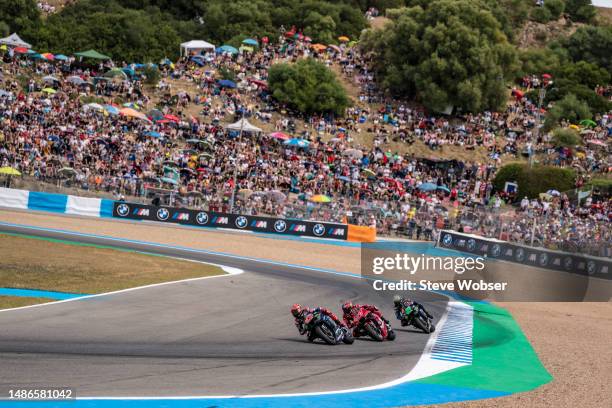 Fabio Quartararo of France and Monster Energy Yamaha MotoGP rides in front of Augusto Fernandez of Spain and Tech3 GASGAS Factory Racing and Franco...