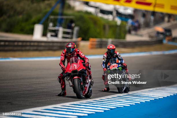 Augusto Fernandez of Spain and Tech3 GASGAS Factory Racing rides in front of Fabio Quartararo of France and Monster Energy Yamaha MotoGP during the...