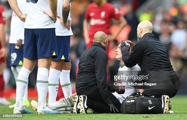Oliver Skipp of Tottenham Hotspur receives medical treatment during the Premier League match between Liverpool FC and Tottenham Hotspur at Anfield on...