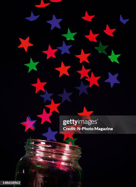 Abstract image of coloured stars streaming from an open glass jar, taken on October 12, 2011.