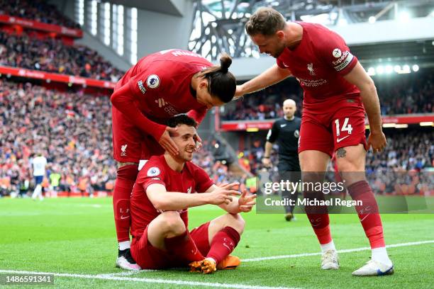 Diogo Jota of Liverpool celebrates with teammates Darwin Nunez and Jordan Henderson after scoring the team's fourth goal during the Premier League...