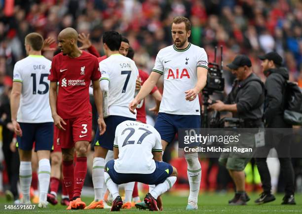 Lucas of Tottenham Hotspur is consoled by team mate Harry Kane after their side's defeat in the Premier League match between Liverpool FC and...