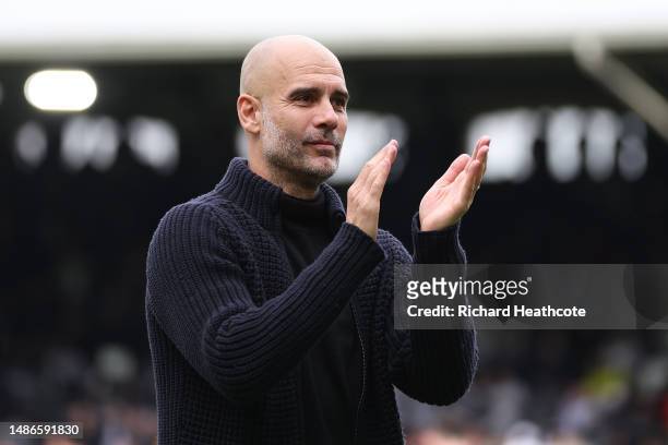 Pep Guardiola, Manager of Manchester City, applauds the fans after the team's victory during the Premier League match between Fulham FC and...