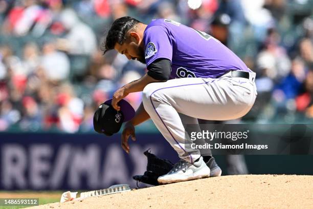 Germán Márquez of the Colorado Rockies reacts after being injured during fourth inning against the Cleveland Guardians at Progressive Field on April...