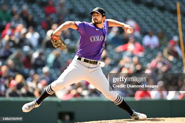 Brad Hand of the Colorado Rockies throws a pitch during the seventh inning against the Cleveland Guardians at Progressive Field on April 26, 2023 in...