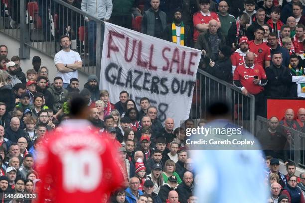 Manchester United fans hold a banner which reads 'Full Sale Glazers Out' during the Premier League match between Manchester United and Aston Villa at...