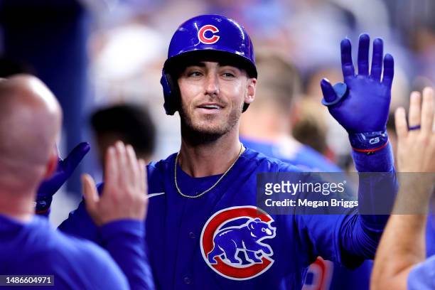 Cody Bellinger of the Chicago Cubs celebrates with teammates after hitting a home run against the Miami Marlins during the sixth inning at loanDepot...