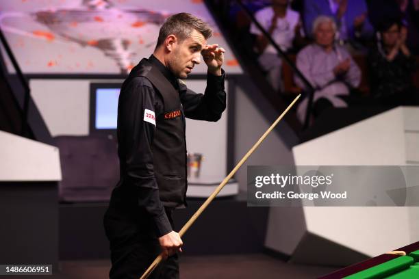 Mark Selby of England reacts during their Final match against Luca Brecel of Belgium on Day Sixteen of the Cazoo World Snooker Championship 2023 at...