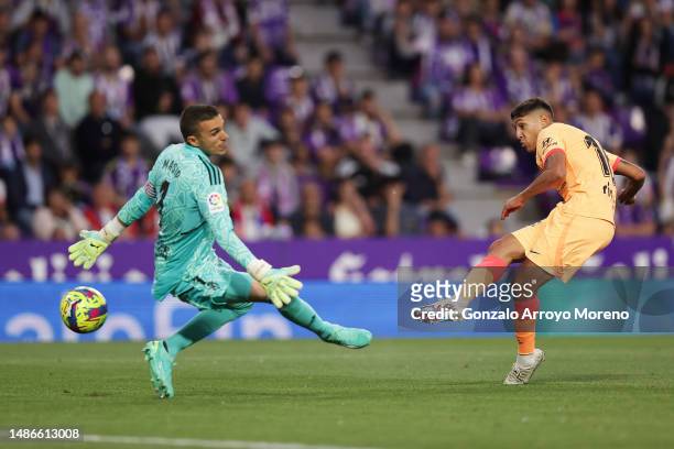 Nahuel Molina of Atletico Madrid scores the team's first goal past Jordi Masip of Real Valladolid CF during the LaLiga Santander match between Real...