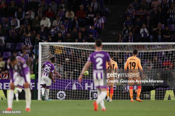 Cyle Larin of Real Valladolid CF scores the team's first goal from a penalty kick past Ivo Grbic of Atletico Madrid during the LaLiga Santander match...