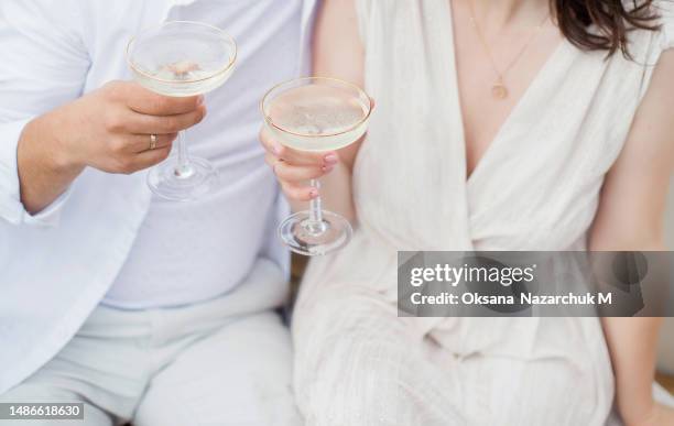 man and woman holding glasses - gin tasting stock pictures, royalty-free photos & images