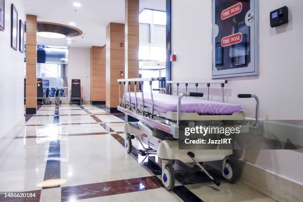 long corridor in hospital with surgical beds - stretcher stock pictures, royalty-free photos & images