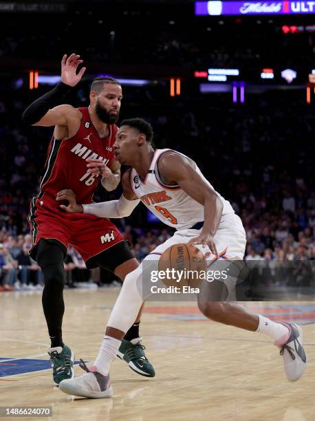 Barrett of the New York Knicks tries to get past Caleb Martin of the Miami Heat in the second half during game one of the Eastern Conference...