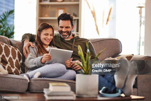 tablet, happy man and teenager girl on sofa checking social media meme and quality time to relax in home. lounge, dad and daughter on couch, internet post and laughing together, bonding and happiness - children interacting with tablet technology stock pictures, royalty-free photos & images