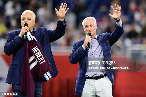 Former USFL player Bobby Hebert receives a Michigan Panthers jersey from USFL President and former NFL player Daryl Johnston at Ford Field on April...