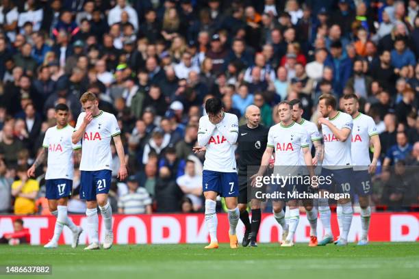Son Heung-min of Spurs and team mates look dejected after the third Liverpool goal during the Premier League match between Liverpool FC and Tottenham...