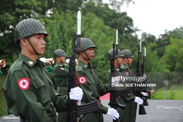 Myanmar army soldiers hold a guard of honor salute to independence hero General Aung San, during a ceremony to mark the country's 65th anniversary of...