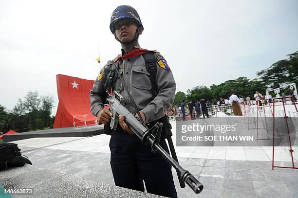 Myanmar army soldier attends a guard of honor salute to independence hero General Aung San, during a ceremony to mark the country's 65th anniversary...