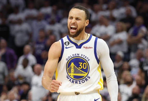 Stephen Curry of the Golden State Warriors celebrates during the third quarter in game seven of the Western Conference First Round Playoffs against...