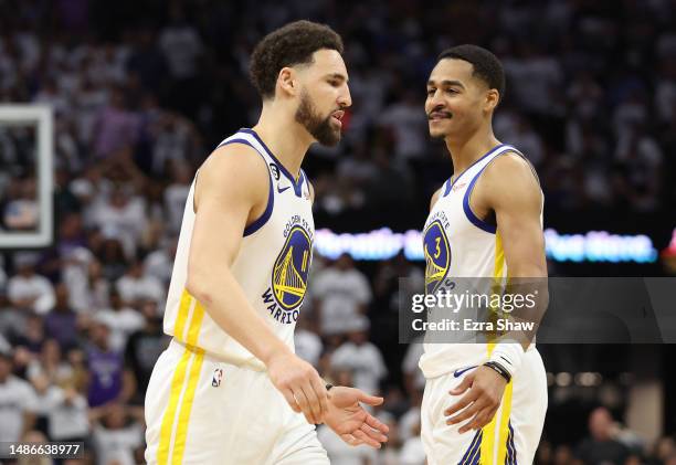 Klay Thompson of the Golden State Warriors reacts with Jordan Poole during the third quarter in game seven of the Western Conference First Round...