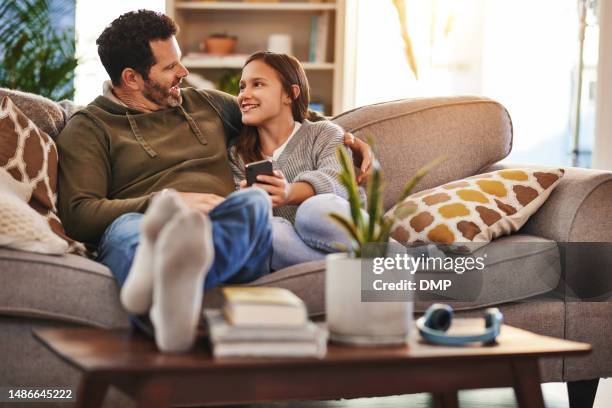 phone, happy man and teenager girl on sofa checking social media meme and quality time to relax in home. lounge, dad and daughter on couch, internet post and laughing together, bonding and happiness. - parent teen stock pictures, royalty-free photos & images