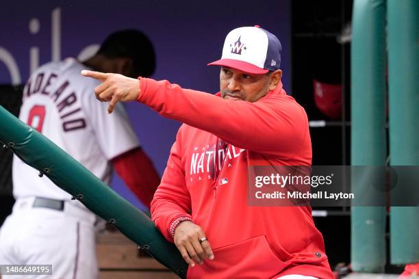 Manager Dave Martinez of the Washington Nationals signals to his players in the second inning during a baseball game against the Pittsburgh Pirates...