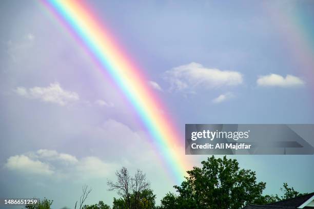 rainbow after rain - rainbow stock pictures, royalty-free photos & images