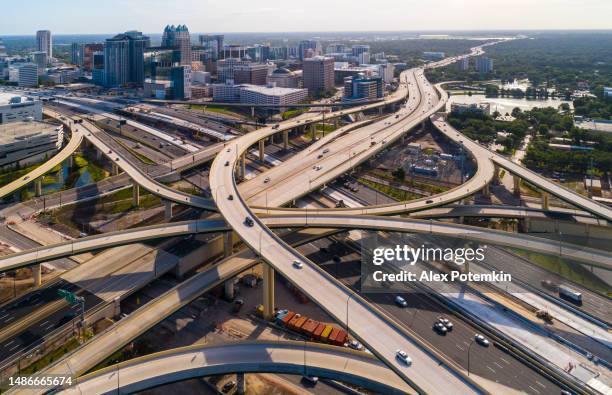 aerial view of downtown orlando over the huge transport junction with highways, and multiple overpasses, in the early morning. extra-large, high-resolution stitched panorama. - orlando florida aerial stock pictures, royalty-free photos & images