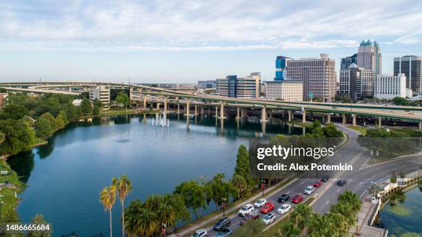 aerial view of downtown orlando over the huge transport junction with highways, and multiple overpasses. - orlando towers stock pictures, royalty-free photos & images