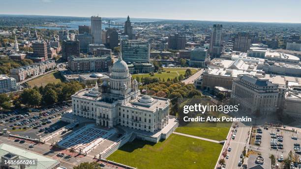 rhode island state house in providens on capitol hill, famous landmark of the city, with a remote view of downtown providence and providence river in the backdrop. - alex day stock pictures, royalty-free photos & images