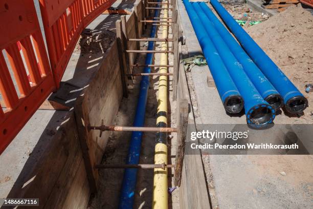 construction site, infrastructure new pipeline under road and sidewalk in the city. - funkwelle stock-fotos und bilder