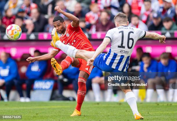 Serge Gnabry of FC Bayern Muenchen is challenged by Jonjoe Kenny of Hertha BSC during the Bundesliga match between FC Bayern München and Hertha BSC...