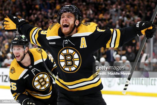 David Pastrnak of the Boston Bruins celebrates with Brandon Carlo after scoring a goal against the Florida Panthers during the third period in Game...
