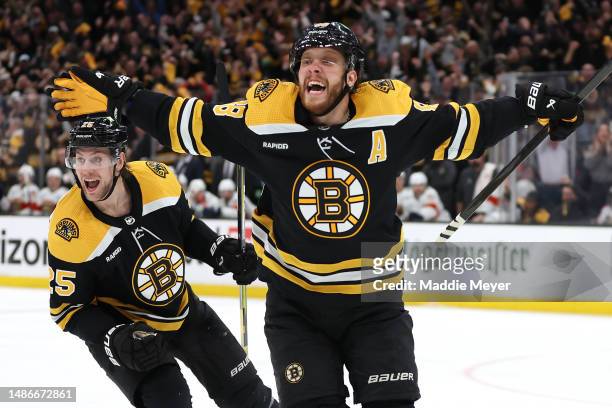 David Pastrnak of the Boston Bruins celebrates with Brandon Carlo after scoring a goal against the Florida Panthers during the third period in Game...